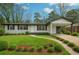 Charming home featuring manicured lawn, tasteful landscaping, and a convenient covered carport at 2401 Winshire Drive, Decatur, GA 30035