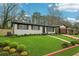 Charming one-story home with a beautifully manicured lawn and mature landscaping at 2401 Winshire Drive, Decatur, GA 30035