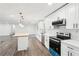 Modern kitchen with stainless appliances, white cabinets, trendy backsplash, butcher block island, and open concept at 2401 Winshire Drive, Decatur, GA 30035