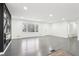 Spacious living room, showcasing modern fireplace feature and hardwood floors, with a view of the front door at 2401 Winshire Drive, Decatur, GA 30035