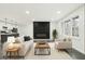 Bright living room featuring modern decor, a fireplace with statement wall, and an open flow to the kitchen at 2401 Winshire Drive, Decatur, GA 30035