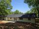 The backyard and rear exterior of the painted brick house feature mature landscaping at 2401 Winshire Drive, Decatur, GA 30035