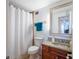 Bathroom featuring a granite countertop, wood cabinets, and a shower with a white curtain at 2479 Peachtree Ne St # 1414, Atlanta, GA 30305
