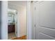 Hallway view of a bathroom with dark wood cabinets and granite countertops at 2479 Peachtree Ne St # 1414, Atlanta, GA 30305