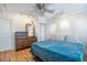 Bright bedroom featuring wood floors, ceiling fan, and a dresser with a large mirror at 2479 Peachtree Ne St # 1414, Atlanta, GA 30305