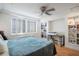Comfortable bedroom with natural light, ceiling fan and built-in shelving with modern decor at 2479 Peachtree Ne St # 1414, Atlanta, GA 30305