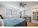 Cozy bedroom featuring plantation shutters, built-in shelving, and a ceiling fan at 2479 Peachtree Ne St # 1414, Atlanta, GA 30305