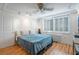 This bedroom features hardwood flooring, a fan, and shutters at 2479 Peachtree Ne St # 1414, Atlanta, GA 30305