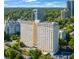 Stunning view of the high-rise condo building showing the pool, parking, and mature trees at 2479 Peachtree Ne St # 1414, Atlanta, GA 30305