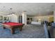 Billiard table in a large room with a lounge area and comfortable seating for entertainment at 2479 Peachtree Ne St # 1414, Atlanta, GA 30305
