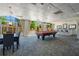 Bright game room with billiard table, a bar area and an outdoor patio with lush greenery at 2479 Peachtree Ne St # 1414, Atlanta, GA 30305