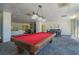 Spacious game room with a red billiard table, a cozy seating area, and a dining area at 2479 Peachtree Ne St # 1414, Atlanta, GA 30305