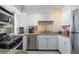 Modern kitchen featuring stainless steel appliances, white cabinets, and granite countertops at 2479 Peachtree Ne St # 1414, Atlanta, GA 30305