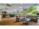 Community lounge with multiple seating areas, long dining table, and a bar for entertaining at 2479 Peachtree Ne St # 1414, Atlanta, GA 30305