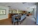A spacious lounge featuring a long dining table with chairs, a wet bar, and comfortable seating areas at 2479 Peachtree Ne St # 1414, Atlanta, GA 30305