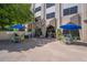 Outdoor patio with tables under umbrellas and manicured greenery for community relaxation at 2479 Peachtree Ne St # 1414, Atlanta, GA 30305