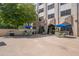 Patio dining area with tables under umbrellas and a grill for outdoor enjoyment at 2479 Peachtree Ne St # 1414, Atlanta, GA 30305