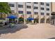 Outdoor patio area with dining tables under umbrellas, plants, and barbecue grill for community enjoyment at 2479 Peachtree Ne St # 1414, Atlanta, GA 30305