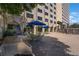Lush outdoor patio area features dining tables under umbrellas, plants, and barbecue grill for community enjoyment at 2479 Peachtree Ne St # 1414, Atlanta, GA 30305