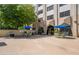 Outdoor patio area features dining tables under umbrellas, plants, and barbecue grill for community enjoyment at 2479 Peachtree Ne St # 1414, Atlanta, GA 30305