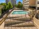 Outdoor pool features crystal-clear water, surrounded by a secure fence and multiple access points at 2479 Peachtree Ne St # 1414, Atlanta, GA 30305