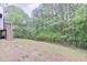 Backyard with a chain link fence and a view of the back deck and the woods at 405 Settlers Ridge Ln, Hiram, GA 30141