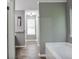 Bright bathroom featuring neutral paint, white trim, and wood-look flooring at 405 Settlers Ridge Ln, Hiram, GA 30141
