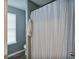 Bathroom featuring a shower tub combination with shower curtain and window with blinds at 405 Settlers Ridge Ln, Hiram, GA 30141