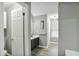Neutral bathroom features a dark vanity, decorative shelf, and wood-look flooring at 405 Settlers Ridge Ln, Hiram, GA 30141