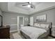 A well lit bedroom featuring hardwood floors, tray ceilings, and a large bed with a desert themed art piece at 405 Settlers Ridge Ln, Hiram, GA 30141