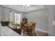 A dining room with a round wood table and four chairs is decorated with plants and an aquarium at 405 Settlers Ridge Ln, Hiram, GA 30141