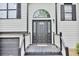 Stylish home entrance with a decorative window above the black front door and black trim at 405 Settlers Ridge Ln, Hiram, GA 30141