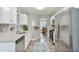 Well-lit kitchen features stainless appliances, white cabinetry, granite counters and hardwood floors at 405 Settlers Ridge Ln, Hiram, GA 30141