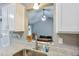 Granite countertops and a garden window add charm to this kitchen with an open view to the living room at 405 Settlers Ridge Ln, Hiram, GA 30141