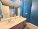 Bright bathroom with double sinks, large mirror, and a shower with a floral curtain at 2365 Hackamore Dr, Atlanta, GA 30349