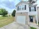 Charming two-story home with gray siding, brick accents, a single car garage, and a well-manicured lawn at 2365 Hackamore Dr, Atlanta, GA 30349