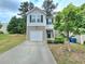 Charming two-story home with gray siding, brick accents, a single car garage, and a well-manicured lawn at 2365 Hackamore Dr, Atlanta, GA 30349