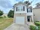 Charming two-story home with gray siding, brick accents, a single car garage, and a well-manicured lawn at 2365 Hackamore Dr, Atlanta, GA 30349