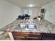 Kitchen island with a double sink and a view into the carpeted living room and comfortable blue sofa set at 2365 Hackamore Dr, Atlanta, GA 30349