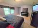 Spacious main bedroom featuring a large bed, dresser, TV, and two windows at 2365 Hackamore Dr, Atlanta, GA 30349