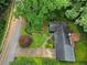 A high-angle shot showcases a property featuring lush greenery and mature trees, close to the road at 4293 Smithsonia Dr, Tucker, GA 30084