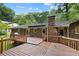 Large wooden back deck offering outdoor living space with railing and backyard view at 4293 Smithsonia Dr, Tucker, GA 30084