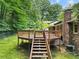 Elevated multi-level backyard deck with stairs and railing at 4293 Smithsonia Dr, Tucker, GA 30084
