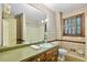Cozy bathroom with floral wallpaper, a classic vanity, and wood trimmed window at 4293 Smithsonia Dr, Tucker, GA 30084