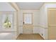 Foyer view featuring neutral walls, beige tile flooring, a wooden door, and a bright window at 4293 Smithsonia Dr, Tucker, GA 30084