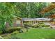 Well-manicured lawn and garden beds lead to this ranch-style home with brick and siding and a brick driveway at 4293 Smithsonia Dr, Tucker, GA 30084