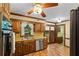 Cozy kitchen features wood cabinets, stainless steel appliances and wood flooring with a view of backyard at 4293 Smithsonia Dr, Tucker, GA 30084