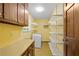 Bright laundry room featuring a modern washing machine, ample storage shelves, and yellow walls at 4293 Smithsonia Dr, Tucker, GA 30084
