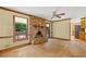Cozy living room with a brick fireplace, wood floors, and bright windows with a view of the deck at 4293 Smithsonia Dr, Tucker, GA 30084