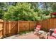 Fenced backyard with a seating area and lush greenery, perfect for relaxation at 786 Brookside Parc Ln, Avondale Estates, GA 30002